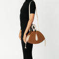 Model wearing NOIRANCA handbag Alice in Brown with a strap