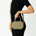 Model wearing NOIRANCA handbag Amanda in Olive Green with a strap