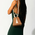 Model wearing NOIRANCA handbag Grace Mini in Brown with a strap