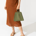 Model holding NOIRANCA handbag Grace in Olive Green