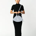 Model wearing NOIRANCA handbag Alice in Maya Blue with a strap