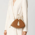 Model wearing NOIRANCA handbag Alice Mini in Brown with a strap