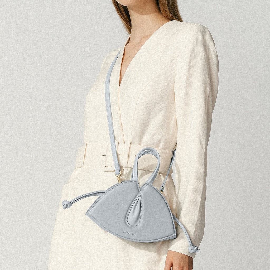 Model wearing NOIRANCA handbag Alice Mini in Maya Blue with a strap