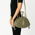 Model wearing NOIRANCA handbag Alice in Olive Green with a strap