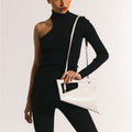 Model wearing NOIRANCA handbag Althea in Ivory with a strap