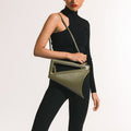 Model wearing NOIRANCA handbag Althea in Olive Green with a strap
