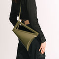 Model wearing NOIRANCA handbag Althea in Olive Green with a strap