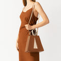 Model wearing NOIRANCA handbag Grace in Brown with a strap