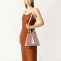 Model wearing NOIRANCA handbag Grace in Dusty Rose with a strap