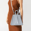 Model wearing NOIRANCA handbag Grace in Maya Blue with a strap