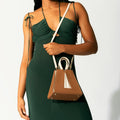 Model wearing NOIRANCA handbag Grace Mini in Brown with a strap
