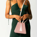Model wearing NOIRANCA handbag Grace Mini in Dusty Rose with a strap