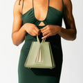 Model holding NOIRANCA handbag Grace Mini in Olive Green