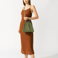 Model wearing NOIRANCA handbag Grace in Olive Green with a strap